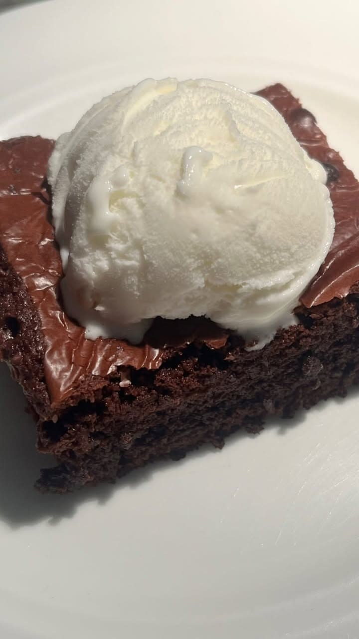 warm brownie under a melting scoop
