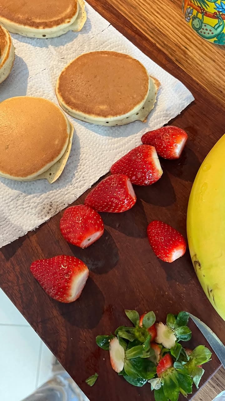 stacked pancakes with sliced strawberries